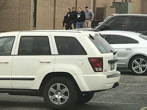 Police escort a person, second from right, out of the Marshall County High School after a shooting there, Tuesday, Jan 23, 2018, in Benton, Ky.