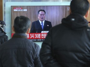Travellers watch a public TV screen showing a North Korean newscaster reading a statement at the Seoul Railway Station in Seoul, South Korea, Wednesday, Jan. 3, 2018. (AP Photo/Ahn Young-joon)