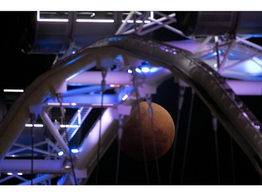 A lunar eclipse is seen through the observation wheel of the Singapore Flyer on Wednesday, Jan. 31, 2018 in Singapore. (AP Photo/Wong Maye-E)