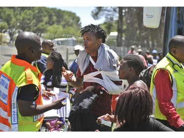 An injured passenger receives attention at the scene of a train accident near Kroonstad, South Africa, Thursday, Jan 4, 2018.