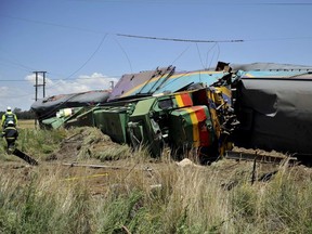 Emergency workers and ruined carriages at the scene of a train accident near Kroonstad, South Africa, Thursday, Jan 4, 2018.