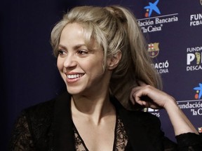 In this March 28, 2017 file photo, Colombian singer Shakira smiles before a press conference for a charity event at the Camp Nou stadium in Barcelona, Spain.