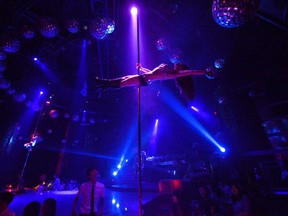 This picture taken on July 2, 2012 shows pole dancing teacher Wang Jing performing at a nightclub in southwest China's Chongqing municipality.