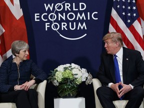 A Thursday, Jan. 25, 2018 file photo of US President Donald Trump meeting with British Prime Minister Theresa May at the World Economic Forum in Davos, Switzerland. President Donald Trump has wished Prince Harry and fiancee Meghan Markle well and says he is not aware of having received an invitation to their royal wedding in May.