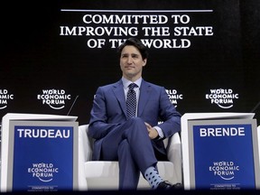 Justin Trudeau, Prime Minister of Canada, sits on the podium prior to his special address on corporate responsibility and the role of women in a changing world during the annual meeting of the World Economic Forum in Davos, Switzerland, Tuesday, Jan. 23, 2018.