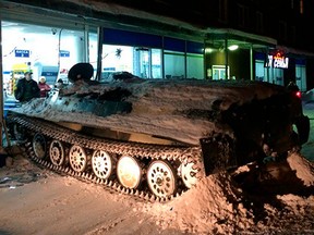 An armored personnel carrier sits next to a shop window it crashed into in Apatity, Murmansk region on the Arctic Kola Peninsula, Russia, Wednesday, Jan. 10, 2018.