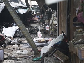 Villagers watch the site of a bombing at a market in Yala province, southern Thailand. Monday, Jan. 22, 2018. Police say a few people have been killed by the explosion.