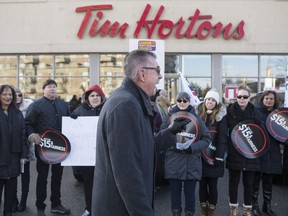 President of Ontario Federation of Labour Chris Buckley addresses protesters outside a Tim Hortons Franchise in Toronto on Wednesday January 10, 2018.