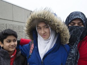 Khawlah Noman and her brother Mohammad Zakarijja (left), appear before the media with their mom Saima Samad, (right) to talk about an alleged hijab-cutting incident on their way to Pauline Johnson Public School in Scarborough on January 12, 2018.