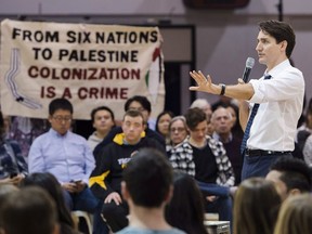 Prime Minister Justin Trudeau listens to a question from protesters during a town hall meeting in Hamilton, Ont., on Wednesday, January 10, 2018.