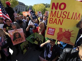 In this Oct. 18, 2017, file photo, protesters gather at a rally in Washington.