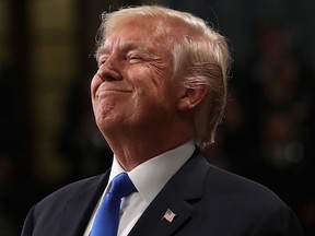 U.S. President Donald Trump smiles during the State of the Union address in the chamber of the US House of Representatives on January 30, 2018 in Washington, D.C.   (WIN MCNAMEE/AFP/Getty Images)
