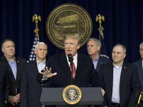 President Donald Trump, center, accompanied by from left, Senate Majority Leader Mitch McConnell of Ky., Vice President Mike Pence, House Majority Leader Kevin McCarthy of Calif., House Majority Whip Steve Scalise, R-La., Secretary of State Rex Tillerson, speaks after participating in a Congressional Republican Leadership Retreat at Camp David, Md., Saturday, Jan. 6, 2018.