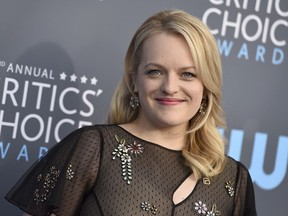 FILE - In a Thursday, Jan. 11, 2018 file photo, Elisabeth Moss arrives at the 23rd annual Critics' Choice Awards at the Barker Hangar, in Santa Monica, Calif. The wrenching loss of an infant to a totalitarian society is explored in season two of "The Handmaid's Tale," star Elisabeth Moss and the show's producers said. The show returns April 25 on streaming service Hulu.