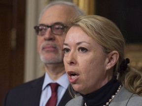 Quebec Labour Minister Dominique announces an increase in the minimum wage, as Quebec Finance Minister Carlos Leitao, left, looks on, Thursday, Jan. 19, 2017 at the legislature in Quebec City. THE CANADIAN PRESS/Jacques Boissinot