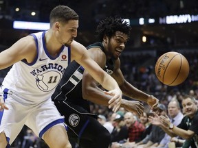 Milwaukee Bucks' Sterling Brown steals the ball from Golden State Warriors' Klay Thompson during the first half of an NBA basketball game Friday, Jan. 12, 2018, in Milwaukee.