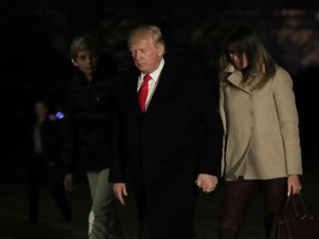 U.S. President Donald Trump together with first lady Melania Trump and their son Barron Trump returns to the White House in Washington, Monday, Jan. 1, 2018, from a holiday break at his Mar-a-Lago estate in Palm Beach, Fla. (AP Photo/Manuel Balce Ceneta)