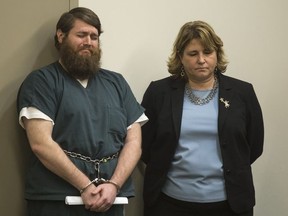 James Chelekis, standing next to his attorney, Shawn Perry, cries as his ex-wife reads a statement at the Kent County Courthouse in downtown Grand Rapids, Mich., on Tuesday, Jan. 23, 2018.  Chelekis, a former teacher has been sentenced to 30 to 60 years in prison for slashing his wife's throat after she discovered he was having an affair with someone who turned out to be a middle-school student.