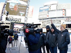 Troy Terry waves to the crowd as the roster for the men's USA Olympic hockey team is announced during the Winter Classic at CitiField on Jan. 1, 2018