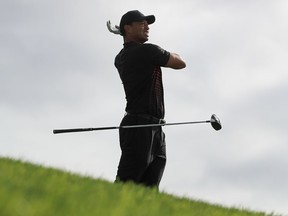 Tiger Woods reacts after playing his shot from the 12th tee during the first round of the Farmers Insurance Open at Torrey Pines South on Jan. 25, 2018