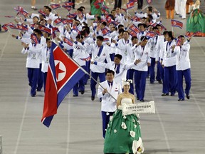 In this Sept. 19, 2014, file photo. athletes from North Korea march into the stadium during the opening ceremony for the 17th Asian Games in Incheon, South Korea. North Korea attended the Asian Games in Incheon, South Korea. At the close of the event, three top North Korean officials made a surprise visit and held the highest-level face-to-face talks with South Korea in five years.
