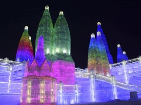 In this Jan. 2, 2018 photo,  the attractions are lit at the Harbin International Ice and Snow Festival in Harbin in northeastern China's Heilongjiang Province. The Harbin International Ice and Snow Festival is known for massive, elaborate and colorfully lit ice sculptures featuring animals, cartoon characters and famous landmarks. (Chinatopix via AP)