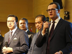 CEO of Ocean Infinity Limited, Oliver Plunkett, right, speaks at a press conference during the MH370 missing plane search operations signing ceremony between the governement of Malaysia and the Ocean Infinity Limited in Putrajaya, Malaysia, Wednesday, Jan. 10, 2018.