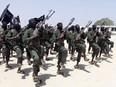 In this Thursday, Feb. 17, 2011 file photo, hundreds of newly trained al-Shabab fighters perform military exercises in the Lafofe area some 18 km south of Mogadishu, in Somalia.