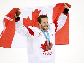 Defenceman Cody Goloubef celebrates Canada's bronze medal at the Pyeongchang Olympics on Feb. 24.