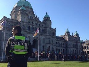 In this file photo, a Victoria Police constable stands watch over a protest at the B.C. legislature.