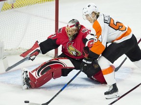 Ottawa Senators goaltender Craig Anderson stretches across the crease to block a shot from Philadelphia Flyers winger Oskar Lindblom during Saturday's game. (THE CANADIAN PRESS)