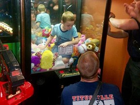 Firefighters rescue a young boy named Mason who got stuck inside a claw-style vending machine Titusville, Fla. on Feb. 7, 2018.