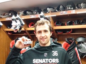 Ottawa's Colin White shows off a souvenir from his first NHL goal. (BRUCE GARRIOCH/Ottawa Sun)