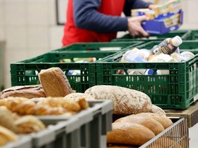 A helper sorts food at the distribution site of the "Essener Tafel" food bank distributing food to people in need in Essen, western Germany, on February 23, 2018.