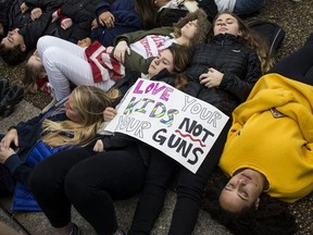 Demonstrators lie on the ground during a "lie-in" demonstration supporting gun control reform near the White House on February 19, 2018 in Washington, DC.