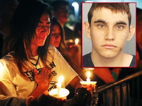 Lavinia Zapata, whose son is a student at Marjory Stoneman Douglas High School, cries during a candlelight vigil for the victims of the Wednesday shooting at the school, in Parkland, Fla., Thursday, Feb. 15, 2018. Nikolas Cruz, a former student, was charged with 17 counts of premeditated murder on Thursday. (AP Photo/Gerald Herbert)