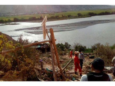 Handout picture released by Arequipa Fire Department showing the accident where at least 35 people were killed when a bus veered off a mountain road and plunged into a ravine on the Panamerican road in southern Peru on February 21, 2018.