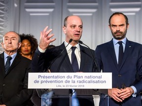 The Prime Minister Edouard Philippe (R) and French Minister of the Interior Gerard Collomb (L) look on as the Minister of National Education Jean-Michel Blanquer (C) gives a speech at the Nord department prefecture for the presentation of the national plan for the prevention of radicalisaton on February 23, 2018, in Lille.