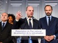 The Prime Minister Edouard Philippe (R) and French Minister of the Interior Gerard Collomb (L) look on as the Minister of National Education Jean-Michel Blanquer (C) gives a speech at the Nord department prefecture for the presentation of the national plan for the prevention of radicalisaton on February 23, 2018, in Lille.