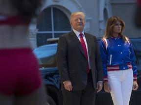 US President Donald Trump and First Lady Melania Trump watch the Florida Atlantic University Marching Band and cheerleaders perform prior to a Super Bowl party at Trump International Golf Club in West Palm Beach, Florida, February 4, 2018.