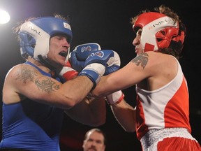 Conservative Senator Patrick Brazeau lands a punch on Liberal MP Justin Trudeau during the charity boxing match at the Hampton Inn Hotel in Ottawa,  March 31, 2012.
