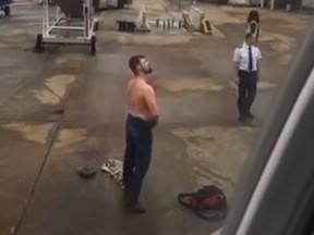 An unnamed man kicked off an American Airlines flight in Charlotte, N.C. took off his shirt and tried to fight airport staff. (YouTube/Storyful)