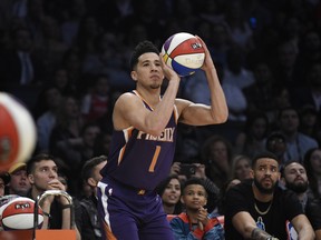 Phoenix Suns' Devin Booker shoots during the NBA basketball All-Star weekend 3-point contest on Saturday Booker won the event. (AP Photo/Chris Pizzello)