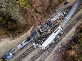 An aerial view of the site of an early morning train crash Sunday, Feb. 4, 2018 between an Amtrak train, bottom right, and a CSX freight train, top left, in Cayce, SC. The Amtrak passenger train slammed into a freight train in the early morning darkness Sunday, killing at least two Amtrak crew members and injuring more than 110 people, authorities said. (AP Photo/Jeff Blake)