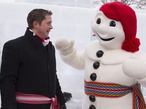 Conservative Leader Andrew Scheer meets Bonhomme at the Palais de Bonhomme as part of Quebec's winter carnival, Friday, Feb. 2, 2018 in Quebec City.