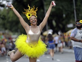 In this Saturday, Feb. 3, 2018 photo, a woman in costume strikes a pose during the Bicho Maluco Beleza carnival "bloco" parade in Sao Paulo, Brazil. This year, the metropolis that many have traditionally seen as too serious to host a good party expects 4 million people to flood the streets, making the celebrations in Brazil's financial capital competitive with those in Salvador and Rio.