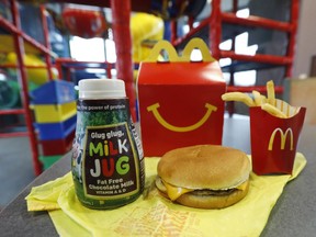 A Happy Meal featuring non-fat chocolate milk and a cheeseburger with fries, are arranged for a photo at a McDonald's restaurant in Brandon, Miss., Wednesday, Feb. 14, 2018.