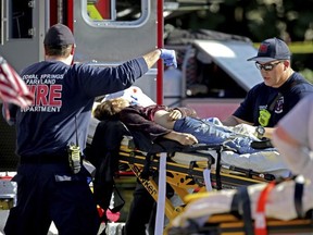 Medical personnel tend to a victim following a shooting at Marjory Stoneman Douglas High School in Parkland, Fla., on Wednesday, Feb. 14, 2018.
