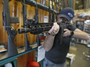 Dordon Brack, aims a semi-automatic AR-15 that is for sale at Good Guys Guns & Range on February 15, 2018 in Orem, Utah. An AR-15 was used in the Marjory Stoneman Douglas High School shooting in Parkland, Florida. (Photo by George Frey/Getty Images)