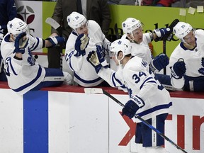 Maple Leafs centre Auston Matthews (34) is congratulated by teammates after scoring a goal against the Red Wings in the third period on Sunday, Feb. 18, 2018, in Detroit. (AP Photo/Jose Juarez)